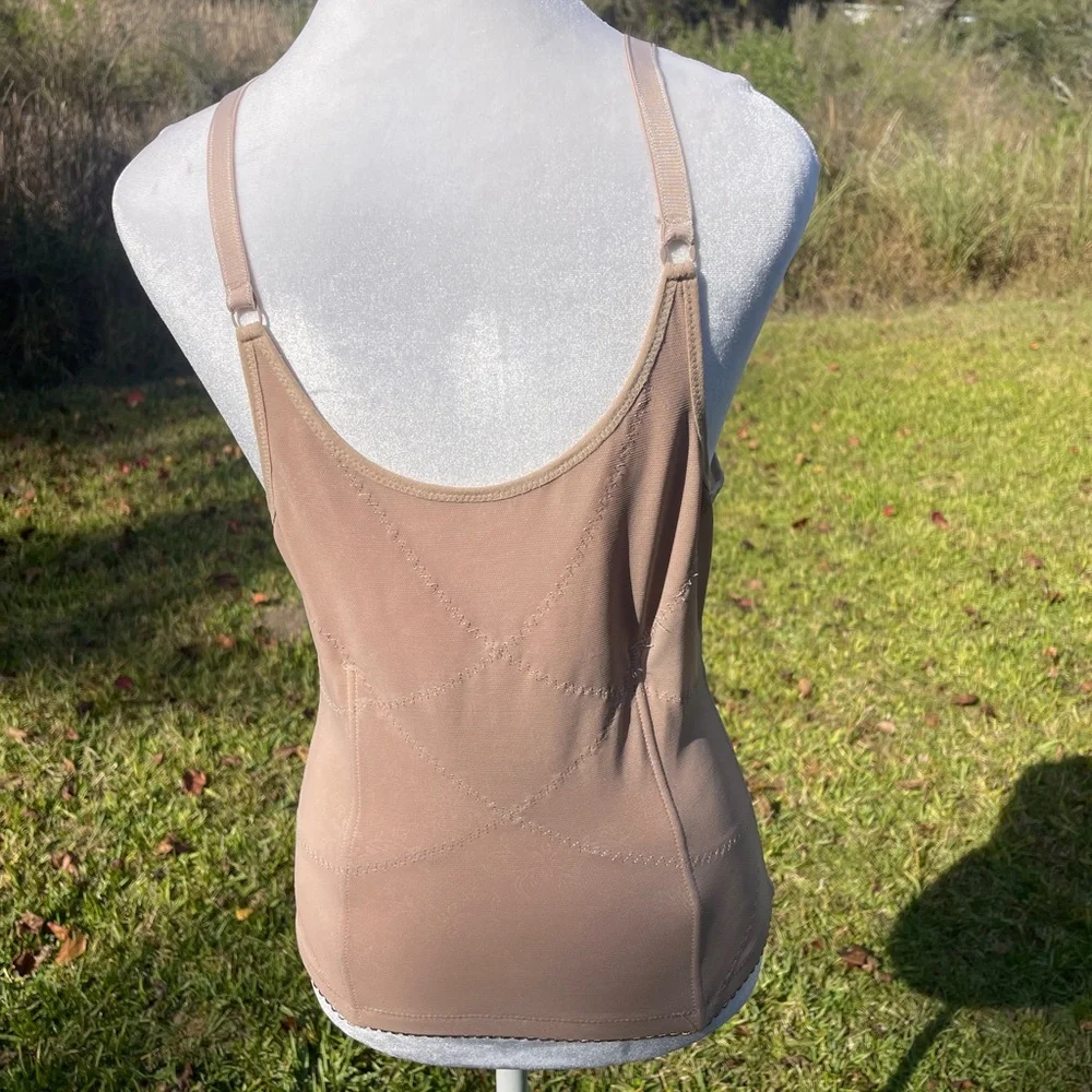 Corset body shaper in beige or nude with adjustable straps & hook/eye closure.